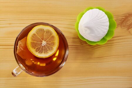 Black tea with lemon cake and marshmallowsの写真素材