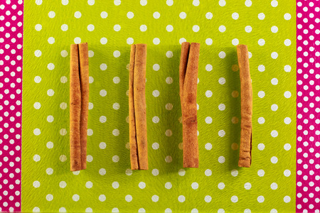 Cinnamon sticks lie on a glass cutting boardの写真素材