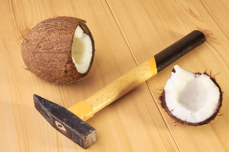 Coconut and hammer on the wooden table