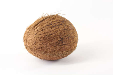 One whole ripe coconut on a white background