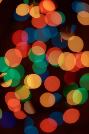 Blurred colored circles on a black backgroundの写真素材