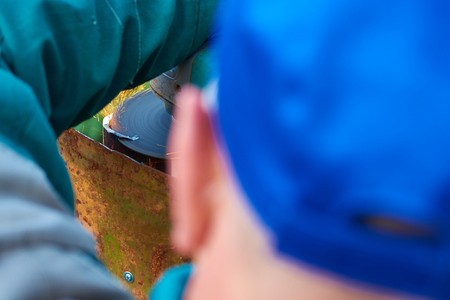 Angle grinder cuts rusty metal plate sparks ventの写真素材