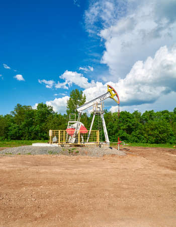 Oil pumping station machine rocking spring against the sky