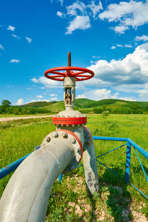 Gas pipe with a tap valve in the summerの写真素材