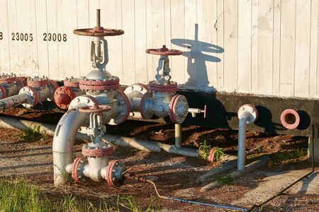 Oil pipeline with a tap valve in the summerの写真素材