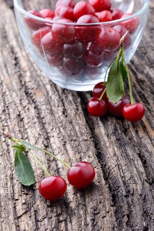 Ripe cherry lying on an old wooden tableの写真素材