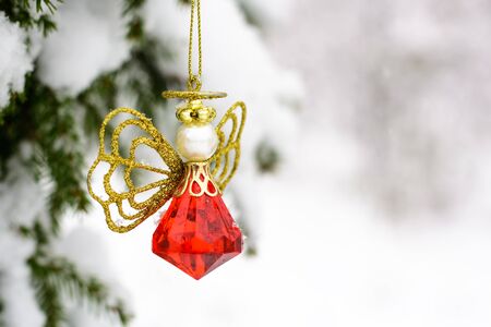 Christmas toys hanging on fir branches snowの写真素材