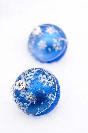 New Year's toys lie on the white snowの写真素材