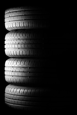Four car summer tires in dramatic lightingの写真素材