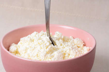 Air cottage in a deep plate and a metal spoonの写真素材