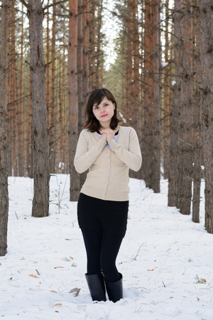 A young woman in cold winter forestの写真素材