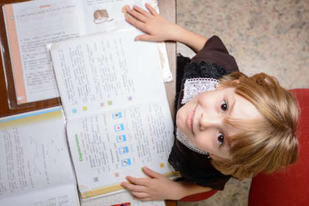 Schoolgirl teach homework and wants to relaxの写真素材