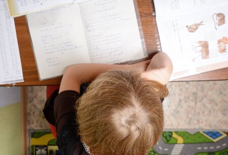 Schoolgirl teach homework and wants to relaxの写真素材