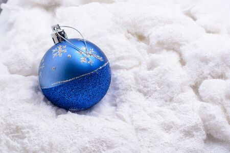 Blue Christmas toy lying in the snow cotton woolの写真素材