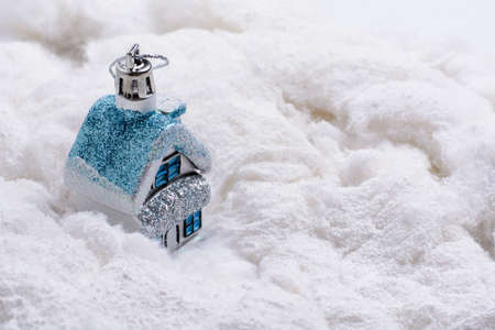 Christmas toy house standing in the snow cotton woolの写真素材