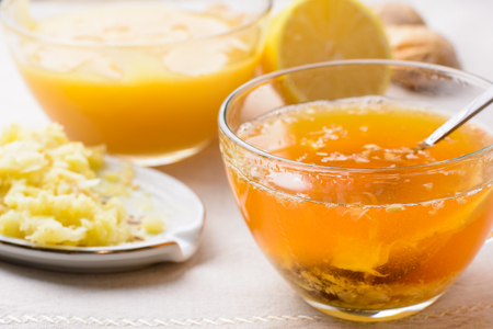Cup of tea with lemon, honey and ginger on a napkinの写真素材