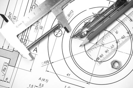 Measuring and drawing instruments and drawings on the tableの写真素材