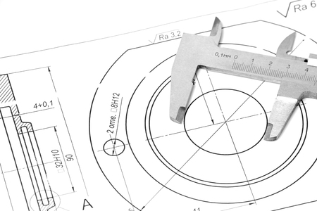 Measuring and drawing instruments and drawings on the tableの写真素材