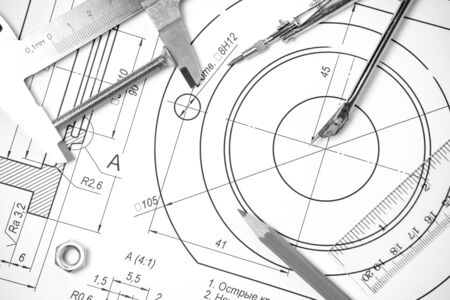 Measuring and drawing instruments and drawings on the tableの写真素材