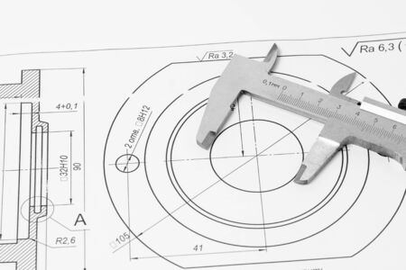 Measuring and drawing instruments and drawings on the tableの写真素材