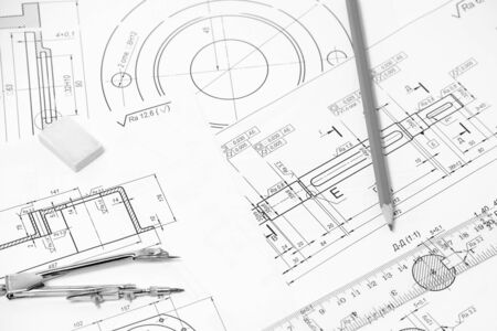 Measuring and drawing instruments and drawings on the tableの写真素材