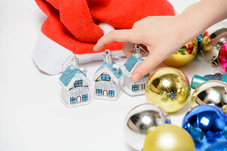 Girl playing with Christmas decorations on a white backgroundの写真素材