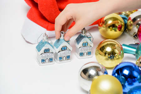 Girl playing with Christmas decorations on a white backgroundの写真素材