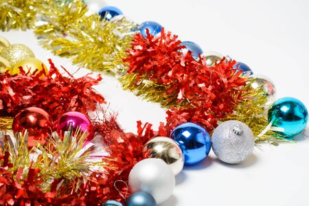 Christmas tinsel and balls on a white backgroundの写真素材
