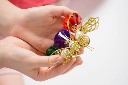 Girl playing with Christmas decorations on a white backgroundの写真素材