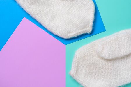 White woolen mittens on a two-tone backgroundの写真素材