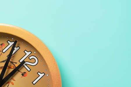 Wall clock five minutes before the new year on a turquoise backgroundの写真素材