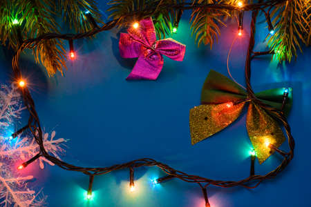 Bows and branches of spruce garlands on the light blue backgroundの写真素材