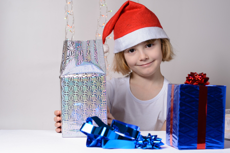 Little girl in santa hat Christmas gift packsの写真素材
