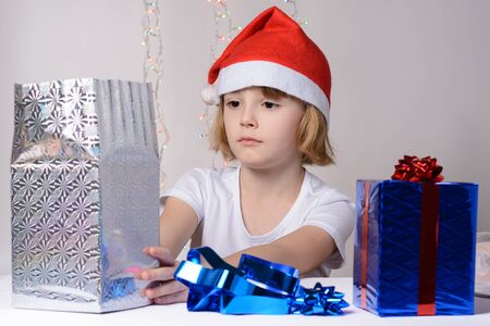 Little girl in santa hat Christmas gift packsの写真素材