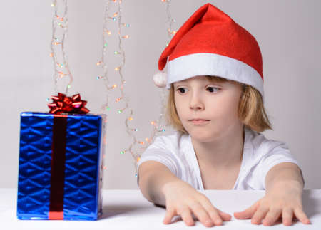 Little girl in santa hat Christmas gift packsの写真素材