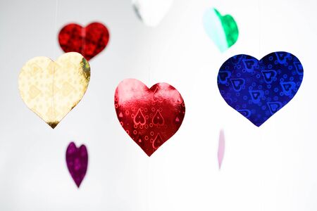 Multicolored paper hearts hanging on the lineの写真素材