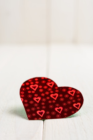 Figures from colored paper in the form of heart on the wooden tableの写真素材