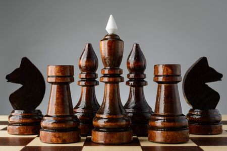 Black king and two knights, bishop and rook on a chessboardの写真素材