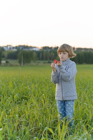 Girl playing with a kite in the springの写真素材