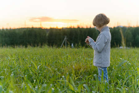 Girl playing with a kite in the springの写真素材