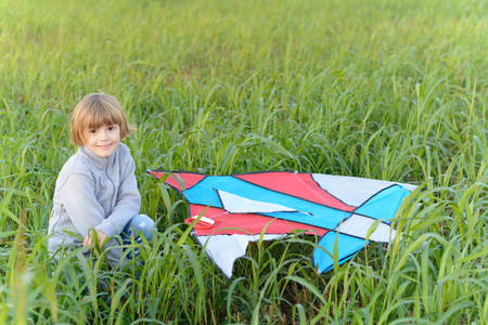 Girl playing with a kite in the springの写真素材