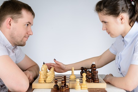 A woman is angry and is going to hand to drop the chess piecesの写真素材