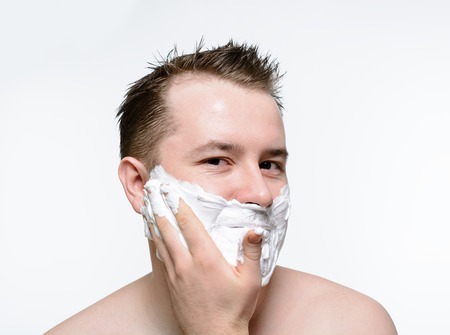 Man shaves shaving foam on a white backgroundの写真素材
