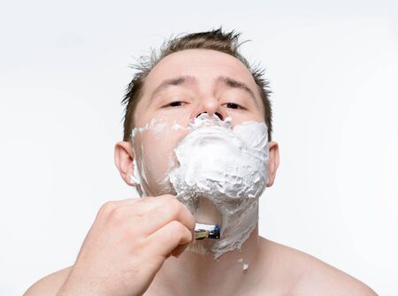 Man shaves shaving foam on a white backgroundの写真素材