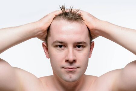 Portrait of a naked man with wet tousled hair