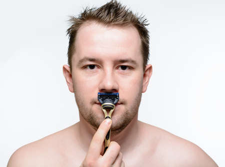 Man shaving machine shaving on a white backgroundの写真素材