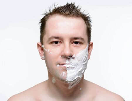 Man shaves shaving foam on a white backgroundの写真素材