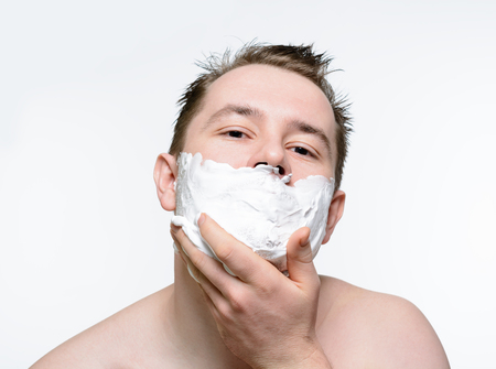 Man shaves shaving foam on a white backgroundの写真素材