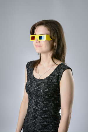 A young Woman black dress in 3d glassesの写真素材