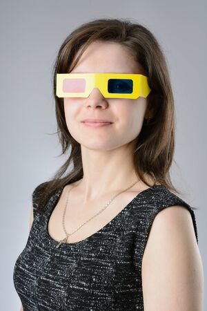 A young Woman black dress in 3d glassesの写真素材